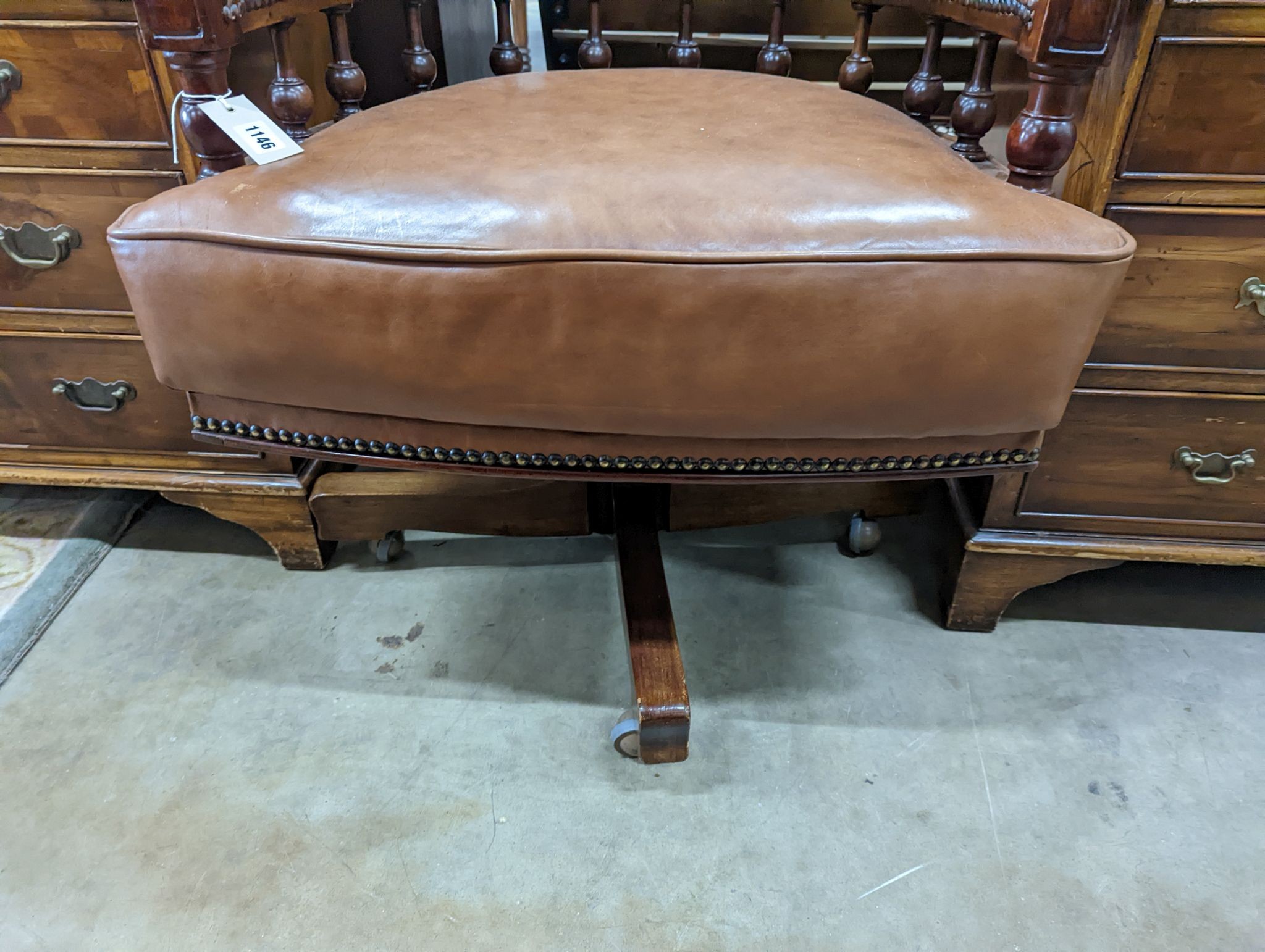 A late Victorian mahogany and tan leather swivel desk chair, width 68cm, depth 63cm, height 77cm